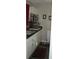 Efficient kitchenette featuring white cabinets, stainless steel microwave and sink at 2980 Haines Bayshore Rd # 124, Clearwater, FL 33760