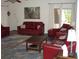 Well-decorated living room featuring cozy red sofas and a stylish coffee table at 2980 Haines Bayshore Rd # 124, Clearwater, FL 33760