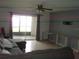 Living room with sliding glass doors leading to a screened lanai and neutral tile flooring at 2980 Haines Bayshore Rd # 124, Clearwater, FL 33760