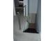 Carpeted stairway with modern railing and adjacent door at 2980 Haines Bayshore Rd # 124, Clearwater, FL 33760