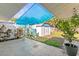Backyard patio area with shed and vibrant landscaping at 306 12Th Ave, Indian Rocks Beach, FL 33785