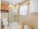 Bathroom with a glass-door shower, cabinet, and a stone-look countertop at 306 12Th Ave, Indian Rocks Beach, FL 33785
