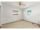 Bedroom with tile floors, two windows at 306 12Th Ave, Indian Rocks Beach, FL 33785