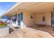 Covered carport area with a side entrance door and blue brick accent walls at 306 12Th Ave, Indian Rocks Beach, FL 33785
