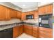A well-equipped kitchen with wooden cabinets and modern appliances at 306 12Th Ave, Indian Rocks Beach, FL 33785