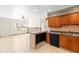 Open kitchen with tiled floors, breakfast bar, and wooden cabinetry at 306 12Th Ave, Indian Rocks Beach, FL 33785