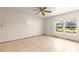 Living room with tile floors and a large window offering plenty of natural light at 306 12Th Ave, Indian Rocks Beach, FL 33785