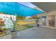 Cozy patio area with tiled floor, blue sun shade, and access to the backyard at 306 12Th Ave, Indian Rocks Beach, FL 33785
