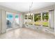 Bright sunroom with tiled floors, large windows, and backyard access at 306 12Th Ave, Indian Rocks Beach, FL 33785