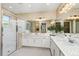 Bright bathroom featuring white vanity, quartz countertop, decorative wall tiling, glass shower with neutral color palette at 3198 Malta Ave, Wesley Chapel, FL 33543