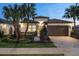 Well-manicured lawn and landscaping frame this house that features a brick driveway and decorative mailbox at 3198 Malta Ave, Wesley Chapel, FL 33543
