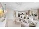 Living room features stylish decor and furnishings, with seamless connection to kitchen and dining areas at 3198 Malta Ave, Wesley Chapel, FL 33543
