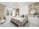 Well-decorated main bedroom with a chandelier, large window, and sophisticated decor at 3198 Malta Ave, Wesley Chapel, FL 33543