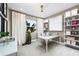 Home office features a sleek desk, shelving units, and a large window with natural light at 3198 Malta Ave, Wesley Chapel, FL 33543