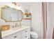 Stylish bathroom showcasing a gold-framed mirror, floating shelves, and modern fixtures for a luxurious feel at 3205 W De Leon St # F, Tampa, FL 33609