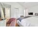 Bright bedroom features a plush pink chair, white walls, and closet for a clean, modern look at 3205 W De Leon St # F, Tampa, FL 33609