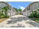 Exterior shot showcasing modern apartments, garage doors, and symmetrical greenery, offering a balanced aesthetic at 3205 W De Leon St # F, Tampa, FL 33609