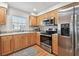 Well-equipped kitchen with stainless steel appliances and wooden cabinets at 3205 W De Leon St # F, Tampa, FL 33609