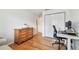 Functional home office setup featuring a classic wooden dresser, desk, chair, and ample closet space at 3205 W De Leon St # F, Tampa, FL 33609