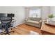 Inviting office space with a comfortable sofa, hardwood floors, and a bright window for a productive atmosphere at 3205 W De Leon St # F, Tampa, FL 33609