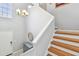 Bright staircase with wooden treads and a modern light fixture at 3205 W De Leon St # F, Tampa, FL 33609