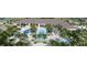 Aerial view of community pools, lounge areas, palm trees, and amenities for residents to enjoy at 32523 Neroli St, Wesley Chapel, FL 33543