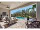 Inviting outdoor patio with comfortable seating overlooking a private pool and lush landscaping at 32523 Neroli St, Wesley Chapel, FL 33543
