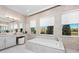 Luxurious bathroom featuring a soaking tub, double vanity, and modern fixtures with natural light at 32523 Neroli St, Wesley Chapel, FL 33543
