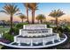 Valencia Ridge community entrance showcasing the tiered water feature and lush landscaping under a vibrant sky at 32523 Neroli St, Wesley Chapel, FL 33543
