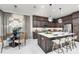 Elegant kitchen featuring dark wood cabinetry, a center island with seating, and adjacent dining area at 32523 Neroli St, Wesley Chapel, FL 33543