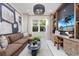 Cozy living room with a comfortable sofa, built-in shelves, and a view of tropical greenery at 32523 Neroli St, Wesley Chapel, FL 33543