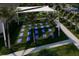 Outdoor yoga area with mats under a sunshade, surrounded by palm trees and lush landscaping at 32523 Neroli St, Wesley Chapel, FL 33543