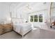 Serene bedroom featuring a plush bed, stylish lighting, decorative molding, and natural light from large windows at 32608 Neroli St, Wesley Chapel, FL 33543