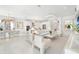 Bright, open living space with modern decor, showcasing a seamless flow between the dining area, living room, and kitchen at 32608 Neroli St, Wesley Chapel, FL 33543