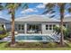 Backyard view showcasing a pristine pool, comfortable seating, and beautifully landscaped area at 32608 Neroli St, Wesley Chapel, FL 33543