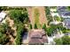 An aerial view displays the home's backyard, including a screened pool and views of green space at 3323 Anna George Dr, Valrico, FL 33596