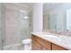 Bathroom features tiled shower with glass door, granite counters, and custom cabinets at 3323 Anna George Dr, Valrico, FL 33596