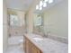 Bathroom featuring a shower-tub combo, vanity with granite countertop, and a large mirror at 3323 Anna George Dr, Valrico, FL 33596