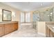 Bathroom with a soaking tub, glass shower, double vanity, and plantation shutters at 3323 Anna George Dr, Valrico, FL 33596