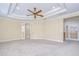 Spacious bedroom featuring a ceiling fan, tray ceiling and french doors with access to other rooms at 3323 Anna George Dr, Valrico, FL 33596