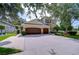 Two-story home featuring a charming exterior with a two-car garage, manicured lawn, and welcoming curb appeal at 3323 Anna George Dr, Valrico, FL 33596