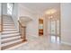 Bright and welcoming foyer with elegant staircase, decorative tile flooring, and a stylish front door at 3323 Anna George Dr, Valrico, FL 33596