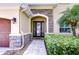 Charming home featuring stone accents, a covered front entry, and lush landscaping at 3323 Anna George Dr, Valrico, FL 33596