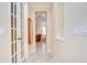 Hallway featuring french doors, a cabinet, and tile flooring leading to the bathroom at 3323 Anna George Dr, Valrico, FL 33596