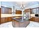 Modern kitchen with stainless steel appliances, custom cabinets, and central island at 3323 Anna George Dr, Valrico, FL 33596