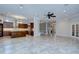 Open-concept living room with kitchen, ceiling fan, and tile flooring at 3323 Anna George Dr, Valrico, FL 33596