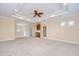 Large open living room with beautiful ceiling details, cabinets and backyard views at 3323 Anna George Dr, Valrico, FL 33596