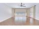 Open living room with hardwood floors, large windows and exterior access at 3323 Anna George Dr, Valrico, FL 33596