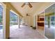 Spacious screened patio with travertine tile flooring and access to the pool and modern kitchen at 3323 Anna George Dr, Valrico, FL 33596