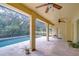 Covered patio featuring a screened-in pool area with lush landscaping, creating a private oasis at 3323 Anna George Dr, Valrico, FL 33596